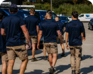 Plumbers walking to their service vans on a Greendale job