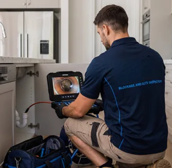 Clearing a blocked sink at a Greendale property